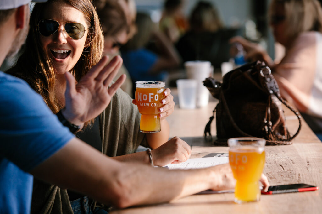 Woman holding NoFo beer