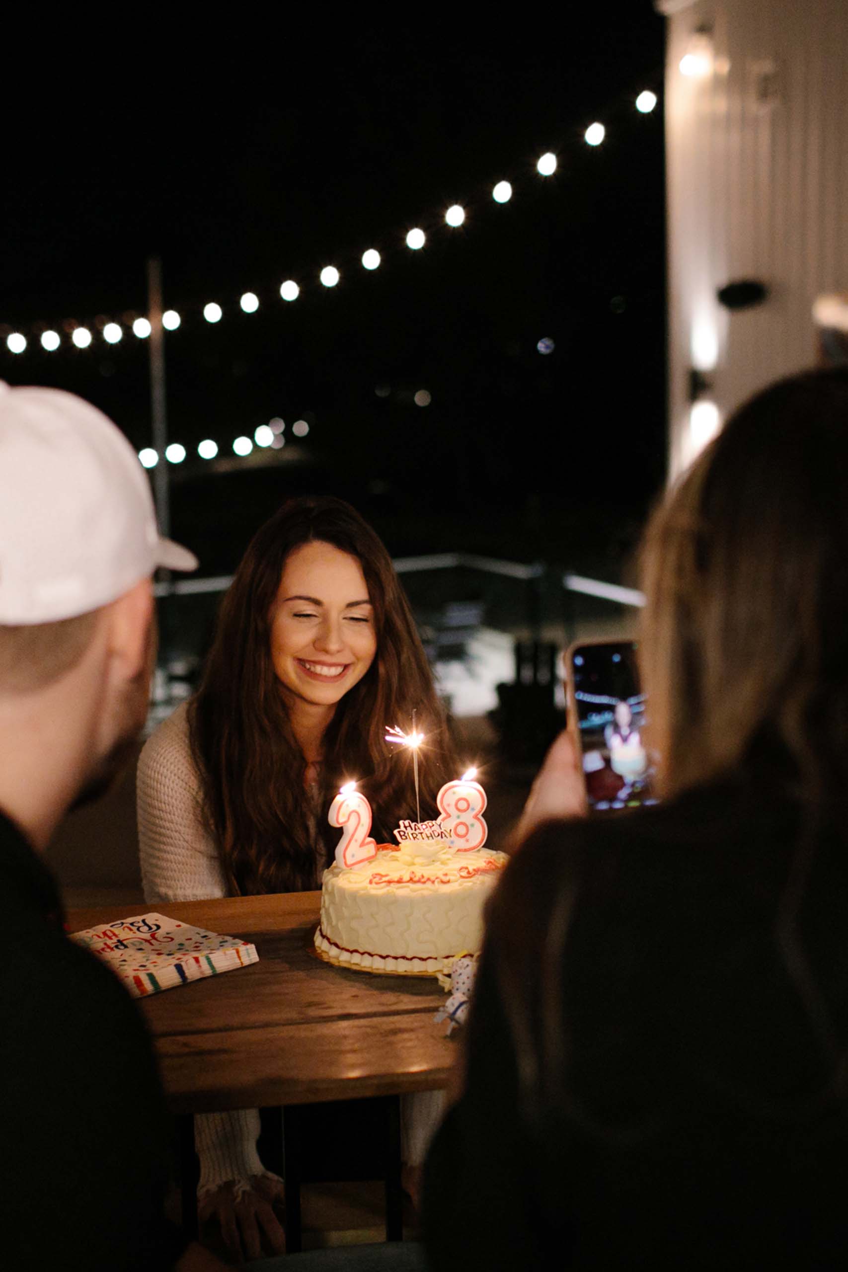 Girl blowing out birthday cake candles